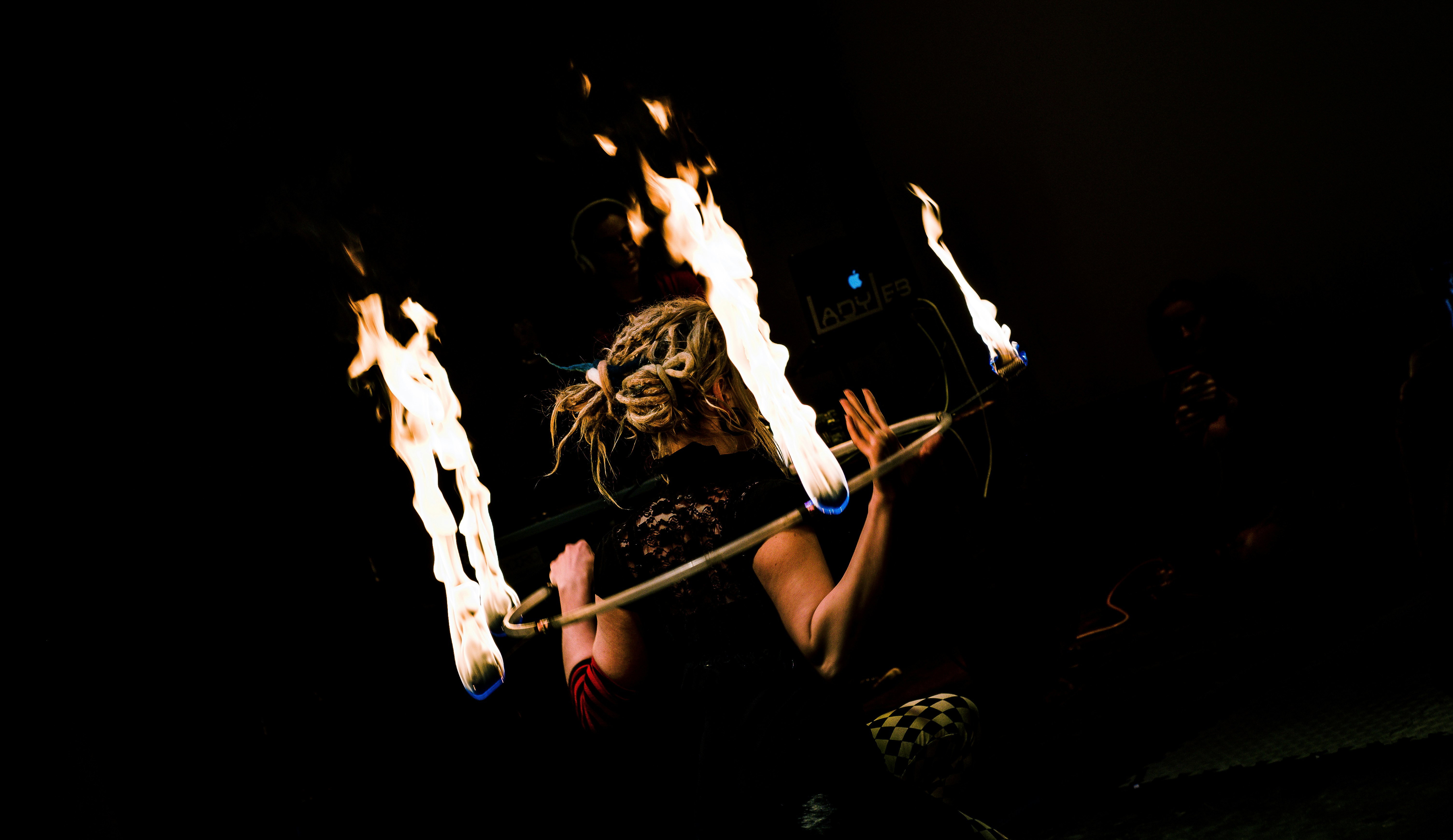 woman holding hula-hoop with fire